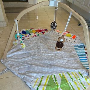 Lovevery playmat with three hanging toys